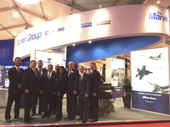 The Marvin Group team stands at the front of its booth, waiting for the Farnborough Air Show Expo Floor to open. 